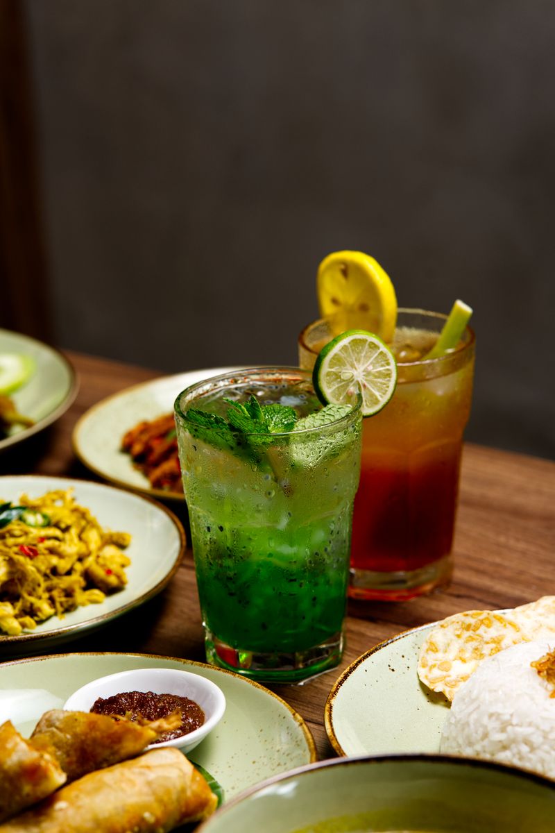 A vibrant spread of vegan dishes on a wooden table, showcasing a colorful stir-fry, chickpea salad,