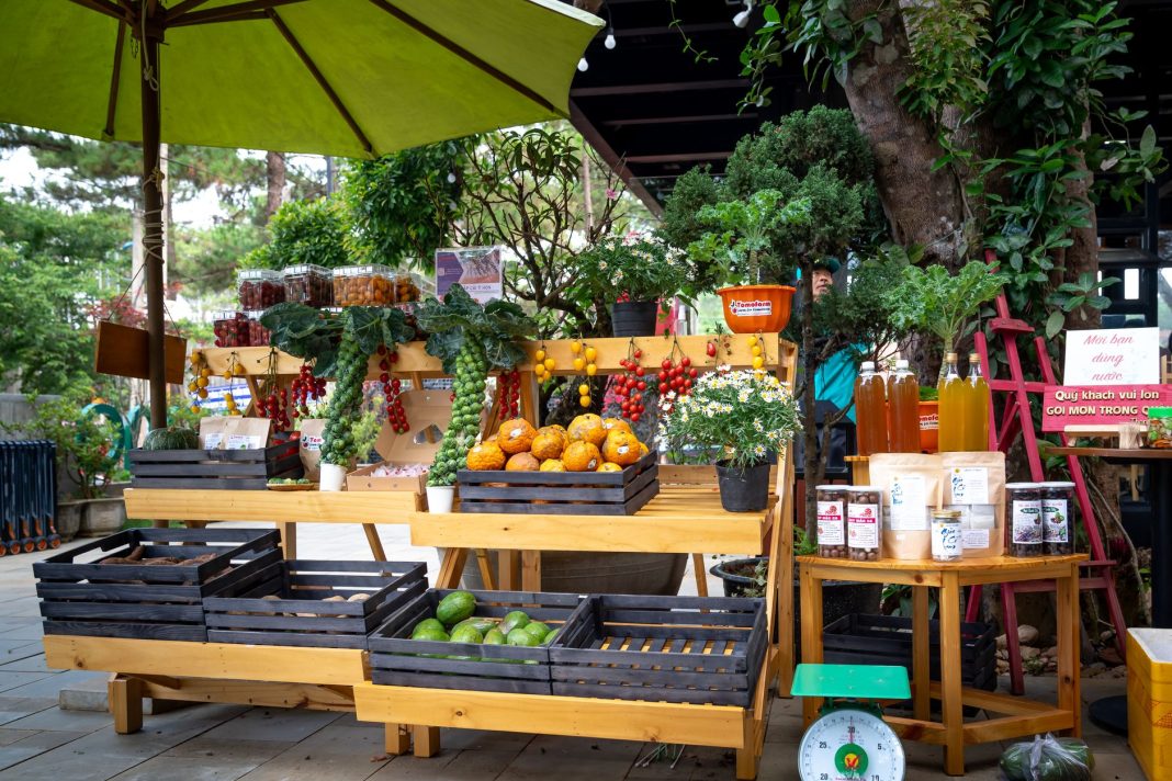 A vibrant farmers' market scene filled with colorful fruits and vegetables, sunlight casting warm to