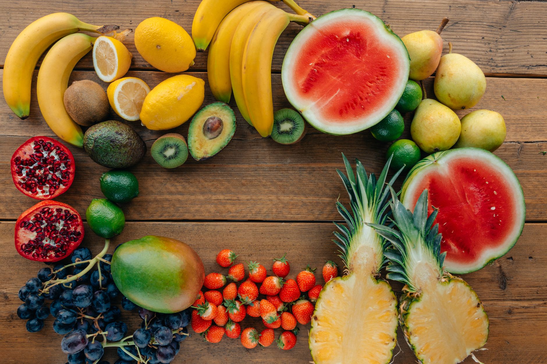 A beautifully arranged raw food platter featuring a colorful variety of fruits, nuts, and vegetables, presented artistically on a rustic wooden table, highlighting the aesthetic appeal of healthy eating, with soft natural light enhancing the colors and textures.