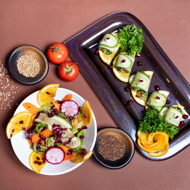 A beautifully plated vegan dish featuring a variety of colorful vegetables and grains, garnished with fresh herbs on a rustic wooden table, showcasing the art of plant-based cooking with an inviting and vibrant presentation.